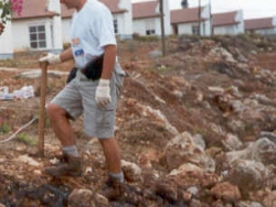 Volunteer working the land