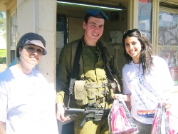 volunteers giving soldier mishloach manot