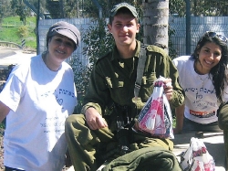 volunteers giving soldier mishloach manot